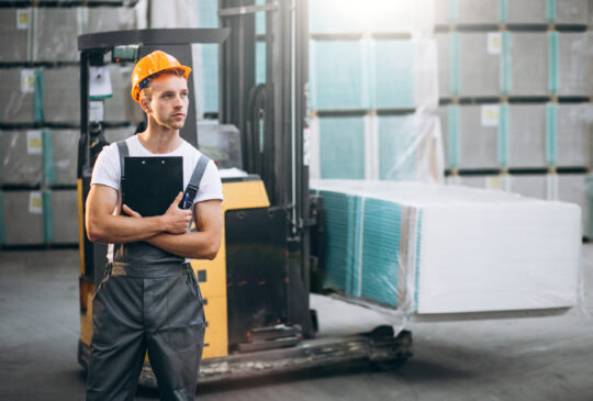 Young man working at a warehouse with boxes
